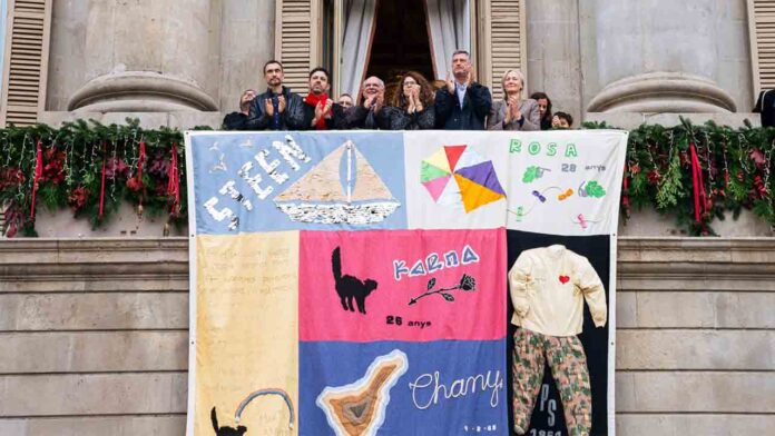 Barcelona despliega el Tapiz Memorial del Sida desde el balcón del Ayuntamiento Barcelona despliega el Tapiz Memorial del Sida desde el balcón del Ayuntamiento